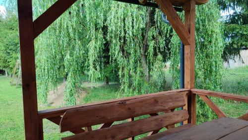 a view from the inside of a porch with a willow tree at Winiec 218/8 in Miłomłyn