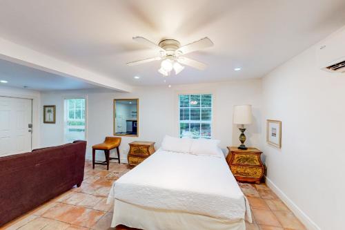 a bedroom with a bed and a ceiling fan at Old Northwood Cottage - A in West Palm Beach