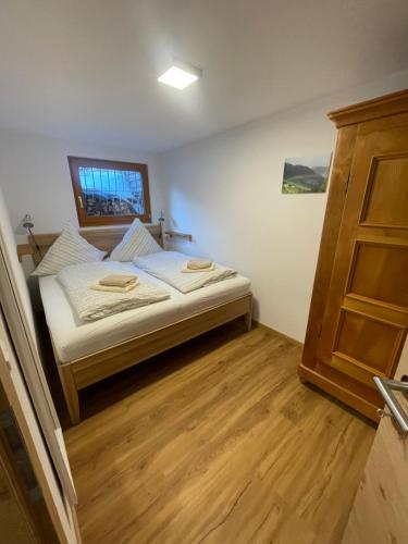 a bedroom with a bed and a wooden floor at Chasa Diana in Samnaun