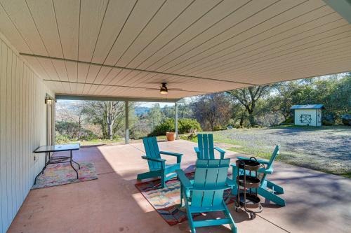 a porch with blue chairs and a table with a view at Bright and Cozy Mariposa Getaway 46 Mi to Yosemite! in Mariposa