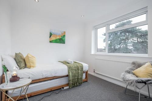 a bedroom with a bed and a window at Newly renovated 5 Bed - Call 4 LONG STAY discount in Winkfield