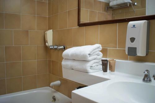 uma casa de banho com lavatório e toalhas num balcão em Soy Local San José em San José