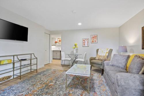 a living room with a couch and a tv at Uncork and Unwind in West Kelowna