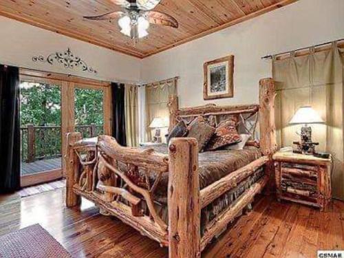 a bedroom with a large wooden bed in a room at Providence Cabin in Townsend
