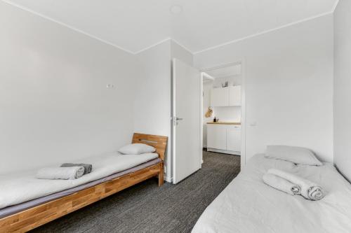 two beds in a room with white walls at Juhkentali 46, korter 5 in Tallinn
