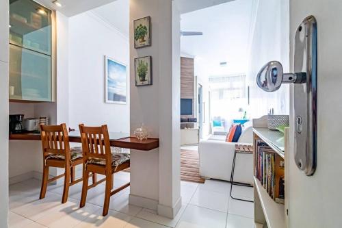 a kitchen with a table and chairs and a refrigerator at Garota de Ipanema in Rio de Janeiro