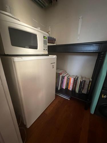 a microwave oven sitting on top of a refrigerator at Beautiful Private Room With King Size Bed in Downtown Orlando in Orlando
