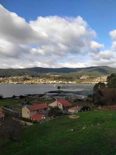 a view of a body of water with houses and buildings at Piso Beiramar in Pontevedra