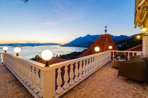 a room with a balcony with a view of the ocean at Pansion Villa Antonio in Orebić