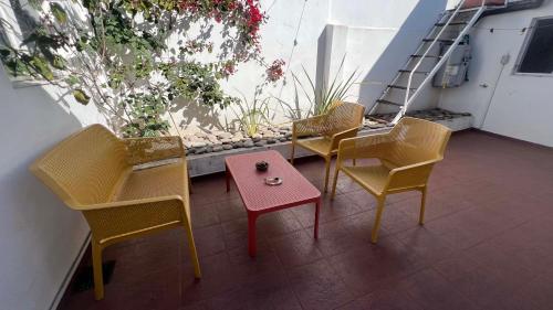 a group of chairs and a table on a balcony at CASA EN LA FELIZ - pet friendly in Mar del Plata