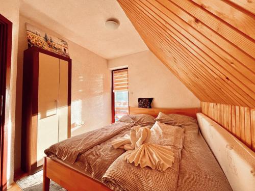 Un dormitorio con una cama con una toalla. en Villa "Pahulja" - Vlašić, en Vlašić