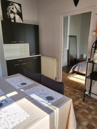 a room with two tables and a room with a bed at Maison de campagne avec jardin près du Périgord in Mansac