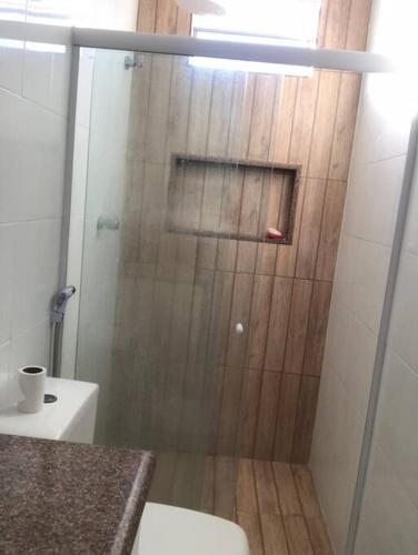 a shower with a glass door in a bathroom at CASA NA PRAIA DO SACO-SE in Estância