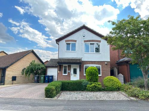 a house with a driveway in front of it at Modern 3 bed House with two bathrooms! Free parking! in Bar Hill
