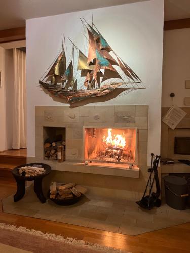 una chimenea con un barco pirata colgando sobre ella en Die Landhausvilla in Unterach am Attersee en Unterach am Attersee