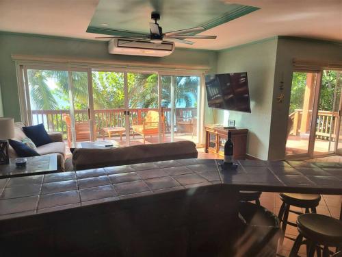 a living room with a couch and a table at Roatan Seaside Rentals in West Bay