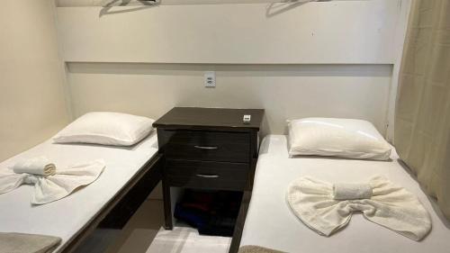 two beds with bow ties on them in a room at Amazon Extreme River Fish in Manaus