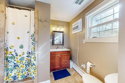 a bathroom with a shower and a sink at Harbor House in Lusby