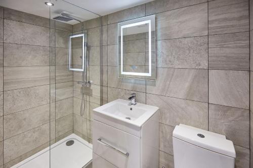 a bathroom with a toilet and a sink at The Hideaway - Apartment 8 in Sunderland