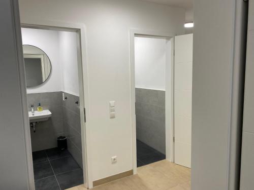 a bathroom with a sink and a mirror at Valley of Business Frankfurt-West - Apartment Nº2 - Two-Bedroom in Hofheim am Taunus