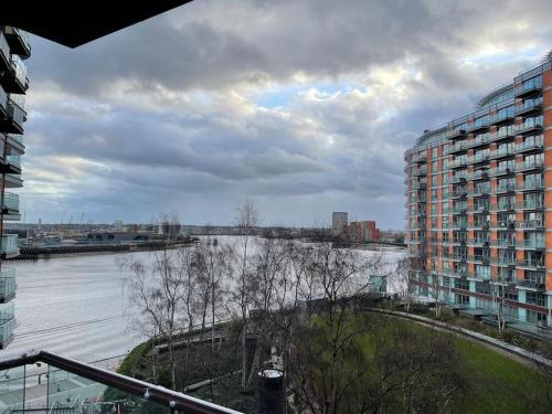a view of a river from a balcony of a building at 1 Bed Modern Flat in London