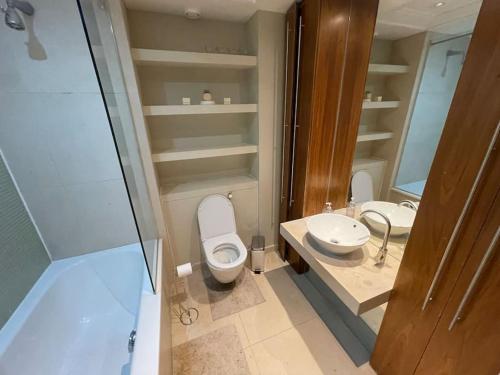 a bathroom with a toilet and a sink at 1 Bed Modern Flat in London