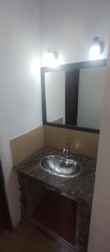 a bathroom with a sink and a mirror at Hospedaje Don Juan in San Javier
