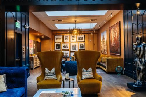 a lobby with couches and chairs and a table at Hotel Lucia in Portland