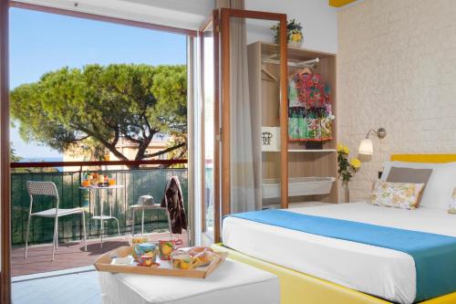 a bedroom with a bed and a balcony with a view at Sorrento Home in Sorrento