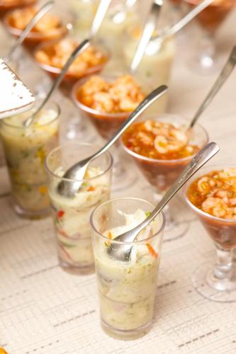a group of glasses of food with spoons in them at Grand Sirenis San Andres in San Andrés