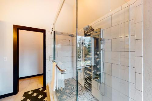 a shower with a glass door in a bathroom at Spokane River Retreat in Coeur d'Alene