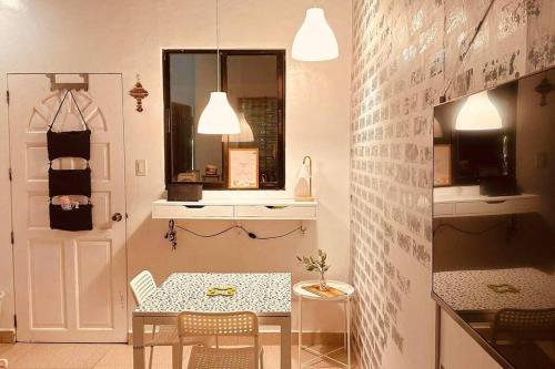 a dining room with a table and a white door at White beach Boracay Apartment A9 in Boracay
