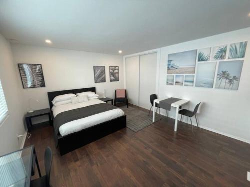 a bedroom with a bed and a desk and a table at House on The Beach in Los Angeles