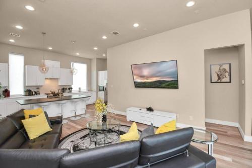 a living room with a couch and a table at Beautiful Luxurious Houston Galleria Home in Houston