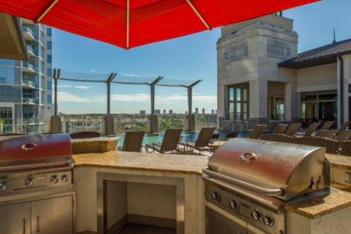 an outdoor kitchen with a view of a building at The Bentler #1 in Houston