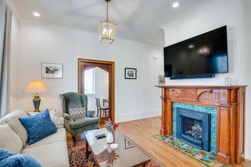 a living room with a fireplace and a tv at Historic Charnwood Guest House- 1 Mile to Downtown in Tyler