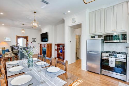 a kitchen and dining room with a table and a refrigerator at Historic Charnwood Guest House- 1 Mile to Downtown in Tyler