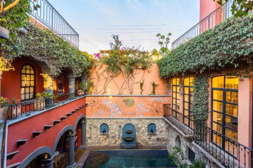 an estate with a swimming pool and ivy at Casa Almira 5BR Luxury Home with Pool, Hot Tub & Rooftop in San Miguel de Allende