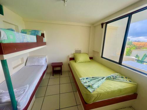 Hostal La Tolita في أتاكاميس: غرفة صغيرة مع سريرين بطابقين ونافذة