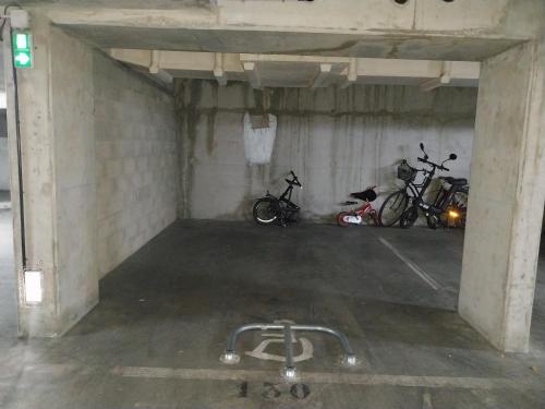 a parking garage with three bikes parked in it at BIG logement , Stade de France à pied, PARIS, métro , parking gratuit in Saint-Denis