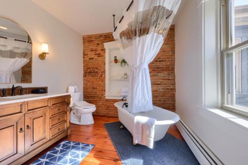 a bathroom with a tub and a toilet and a sink at The Tannery in Lancaster