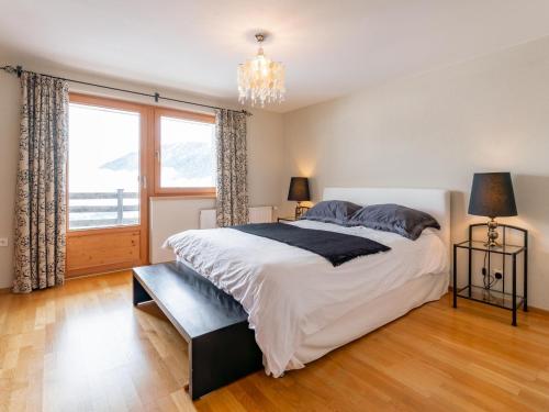 a bedroom with a large bed and a large window at Chalet Mountain View in Alpbach