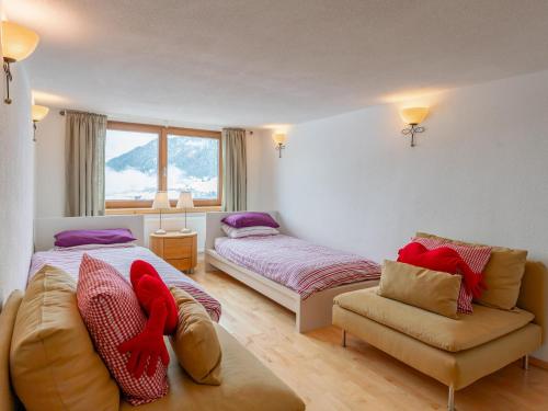 a bedroom with two beds and a couch at Chalet Mountain View in Alpbach