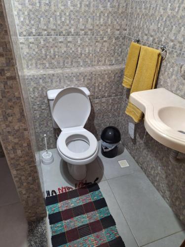 a bathroom with a toilet and a sink at Cantinho da Paz in Niterói