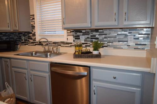 a kitchen with a sink and a dishwasher at Home In Greenville 4 bedrooms, 4 beds, 2 baths in Greenville