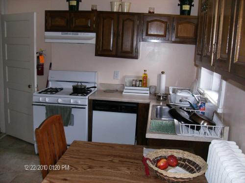 a kitchen with a sink and a stove top oven at Pleasant Rooming House in Washington