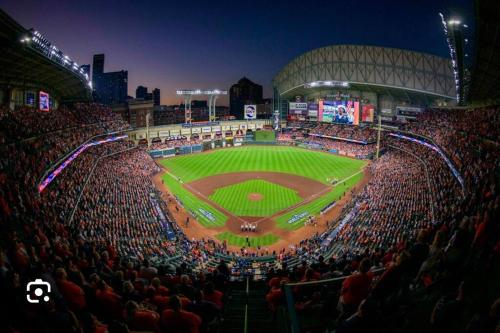 a large crowd of people watching a baseball game at The Bentler #2 in Houston