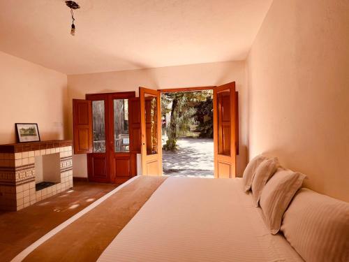 a bedroom with a bed and an open door at Casalinda San Miguel in San Miguel de Allende