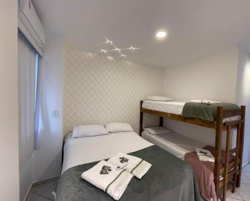 Cette petite chambre comprend 2 lits et des serviettes. dans l'établissement NA PRAIA DE ITAPARICA 2, à Vila Velha