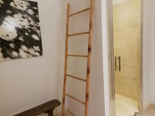 a ladder in a room next to a door at Gîte Ainay-le-Vieil, 5 pièces, 8 personnes - FR-1-586-15 in Ainay-le-Vieil